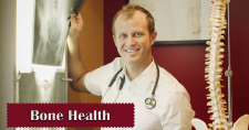 Bone Health Tips. Picture of a caucasian male doctor looking at xrays.